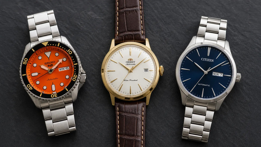 Seiko 5 SRPD on stainless bracelet left, Orient Bambino on leather strap centre, Citizen NH8350 on stainless bracelet right